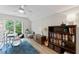 Spacious bedroom with hardwood floors, natural light, drum set, bookshelf, and cozy decor for a vibrant living space at 10817 Brass Kettle Rd, Raleigh, NC 27614