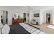 Well-lit bedroom with hardwood floors, a comfortable bed, and a view into a connected sitting room at 10817 Brass Kettle Rd, Raleigh, NC 27614
