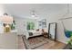 Bright bedroom features hard wood floors, white ceiling fan, white trim and walls, natural light, and cozy decor at 10817 Brass Kettle Rd, Raleigh, NC 27614
