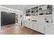 Bright entryway with hardwood floors, built-in shelving, and a view of the front door, providing a warm welcome at 10817 Brass Kettle Rd, Raleigh, NC 27614