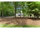 Picturesque view of the home nestled among mature trees, showcasing the property's natural setting at 10817 Brass Kettle Rd, Raleigh, NC 27614