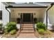 Inviting front entrance with brick steps, black iron railing, and a double door entry way, adding curb appeal at 10817 Brass Kettle Rd, Raleigh, NC 27614