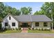 Charming single-story home with a brick walkway and a well-manicured lawn and surrounded by mature trees at 10817 Brass Kettle Rd, Raleigh, NC 27614