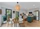 Bright kitchen and dining area with modern appliances, center island, and stylish lighting at 10817 Brass Kettle Rd, Raleigh, NC 27614