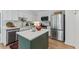 Modern kitchen with stainless steel appliances, custom cabinetry, and a center island at 10817 Brass Kettle Rd, Raleigh, NC 27614