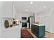 Modern kitchen with stainless steel appliances, custom cabinetry, and a center island at 10817 Brass Kettle Rd, Raleigh, NC 27614