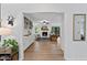 Open-concept living room with hardwood floors, a fireplace, built-in shelving, and lots of natural light at 10817 Brass Kettle Rd, Raleigh, NC 27614