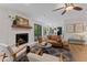 Bright living room features a brick fireplace, hardwood floors, and modern furnishings at 10817 Brass Kettle Rd, Raleigh, NC 27614
