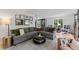 Inviting living room features a comfortable gray sectional sofa, modern decor, and bright natural light at 10817 Brass Kettle Rd, Raleigh, NC 27614