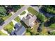 Aerial view of home with brown roof, fire pit, manicured landscaping, and circular driveway at 1101 Temple St, Raleigh, NC 27609