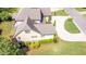 Aerial view of home with driveway basketball hoop, landscaping, and a brown shingle roof at 1101 Temple St, Raleigh, NC 27609