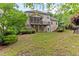 A sprawling backyard showing multiple decks, screened-in porch, and beautiful landscaping at 1101 Temple St, Raleigh, NC 27609
