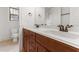 Bathroom with a double sink vanity, wood cabinets, and white countertops at 1101 Temple St, Raleigh, NC 27609