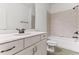 Bathroom features white cabinetry, a shower-tub combo with neutral tile, and bronze fixtures at 1101 Temple St, Raleigh, NC 27609