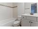 Bathroom with shower-tub, mosaic tile accent and granite vanity at 1101 Temple St, Raleigh, NC 27609