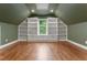 Bedroom with hardwood floors, built-in shelving, and natural light at 1101 Temple St, Raleigh, NC 27609