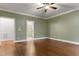 Bedroom with hardwood floors and an ensuite bathroom with glass shower at 1101 Temple St, Raleigh, NC 27609