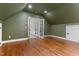 A green bedroom featuring hardwood floors and french doors to another room at 1101 Temple St, Raleigh, NC 27609