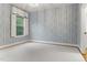 Bedroom featuring patterned wallpaper, neutral carpet, and natural light at 1101 Temple St, Raleigh, NC 27609