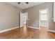 Bedroom with hardwood floors, neutral walls, and a door to a walk-in closet at 1101 Temple St, Raleigh, NC 27609