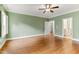 Bedroom featuring hardwood floors, bright windows, and an open entrance to a bathroom at 1101 Temple St, Raleigh, NC 27609