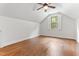 An airy bedroom with hardwood floors, white walls, and a large window at 1101 Temple St, Raleigh, NC 27609