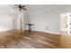 Bonus room featuring hardwood floors, a ceiling fan, and a small bar area at 1101 Temple St, Raleigh, NC 27609