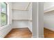 Bright walk-in closet with custom shelving and hardwood floors near window at 1101 Temple St, Raleigh, NC 27609