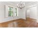 Bright dining room featuring hardwood floors, wainscoting, and shuttered windows at 1101 Temple St, Raleigh, NC 27609