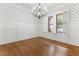 Charming dining room featuring hardwood floors, wainscoting, and natural light from shuttered windows at 1101 Temple St, Raleigh, NC 27609