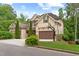 View of this house from the side highlighting the two-car garage with basketball hoop, and well-kept lawn at 1101 Temple St, Raleigh, NC 27609