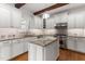 Modern kitchen featuring white cabinets, granite countertops, stainless steel appliances, and hardwood floors at 1101 Temple St, Raleigh, NC 27609