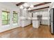Modern kitchen featuring white cabinets, granite countertops, stainless steel appliances, and hardwood floors at 1101 Temple St, Raleigh, NC 27609