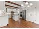 Modern kitchen featuring white cabinets, granite countertops, stainless steel appliances, and hardwood floors at 1101 Temple St, Raleigh, NC 27609