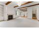 Open-concept living room showcases a fireplace, hardwood flooring, and exposed beams at 1101 Temple St, Raleigh, NC 27609