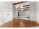 Bright living room with hardwood floors, beamed ceilings, and open floor plan offers a spacious feel at 1101 Temple St, Raleigh, NC 27609