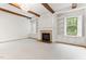 Bright, open living room with fireplace, built-ins and exposed wood beams at 1101 Temple St, Raleigh, NC 27609