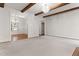 Cozy living area with exposed beams, fireplace, and easy access to other living spaces at 1101 Temple St, Raleigh, NC 27609