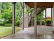 Stamped concrete patio with staircase to backyard surrounded by mature trees and landscaped foliage at 1101 Temple St, Raleigh, NC 27609