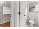 Toilet room with toilet, door to closet, and window at 1101 Temple St, Raleigh, NC 27609