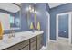 Stylish bathroom with double vanity, framed mirrors, modern lighting, and walk-in shower at 1109 Agio Ct, Zebulon, NC 27597