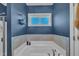 A modern bathroom features a soaking tub, window and elegant tile work at 1109 Agio Ct, Zebulon, NC 27597