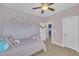 This adorable bedroom features soft colors, cozy carpet, and playful decor at 1109 Agio Ct, Zebulon, NC 27597