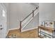 Bright entryway with hardwood floors, staircase, and stylish console table with artwork at 1109 Agio Ct, Zebulon, NC 27597