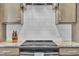 Close-up of kitchen featuring stainless steel range, white subway tile backsplash, and granite countertops at 1109 Agio Ct, Zebulon, NC 27597