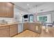Open kitchen view showcasing granite countertops, stainless steel appliances and hardwood flooring at 1109 Agio Ct, Zebulon, NC 27597