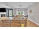 Close up on kitchen island with granite countertops and sink featuring stainless steel faucet fixture at 1109 Agio Ct, Zebulon, NC 27597
