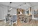 View of kitchen and dining area with a large island, bar stool seating and modern light fixture at 1109 Agio Ct, Zebulon, NC 27597