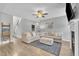 Well lit living room featuring neutral furniture, decor and a staircase leading to the second floor at 1109 Agio Ct, Zebulon, NC 27597