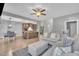 Open-concept living room features a modern kitchen, light hardwood floors and neutral paint at 1109 Agio Ct, Zebulon, NC 27597